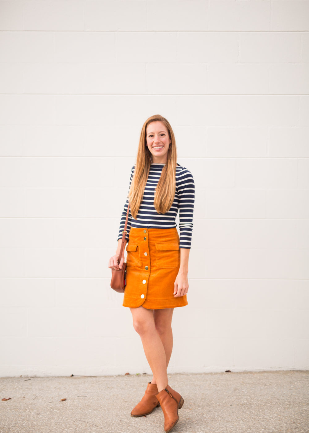 woman in striped top and orange skirt 