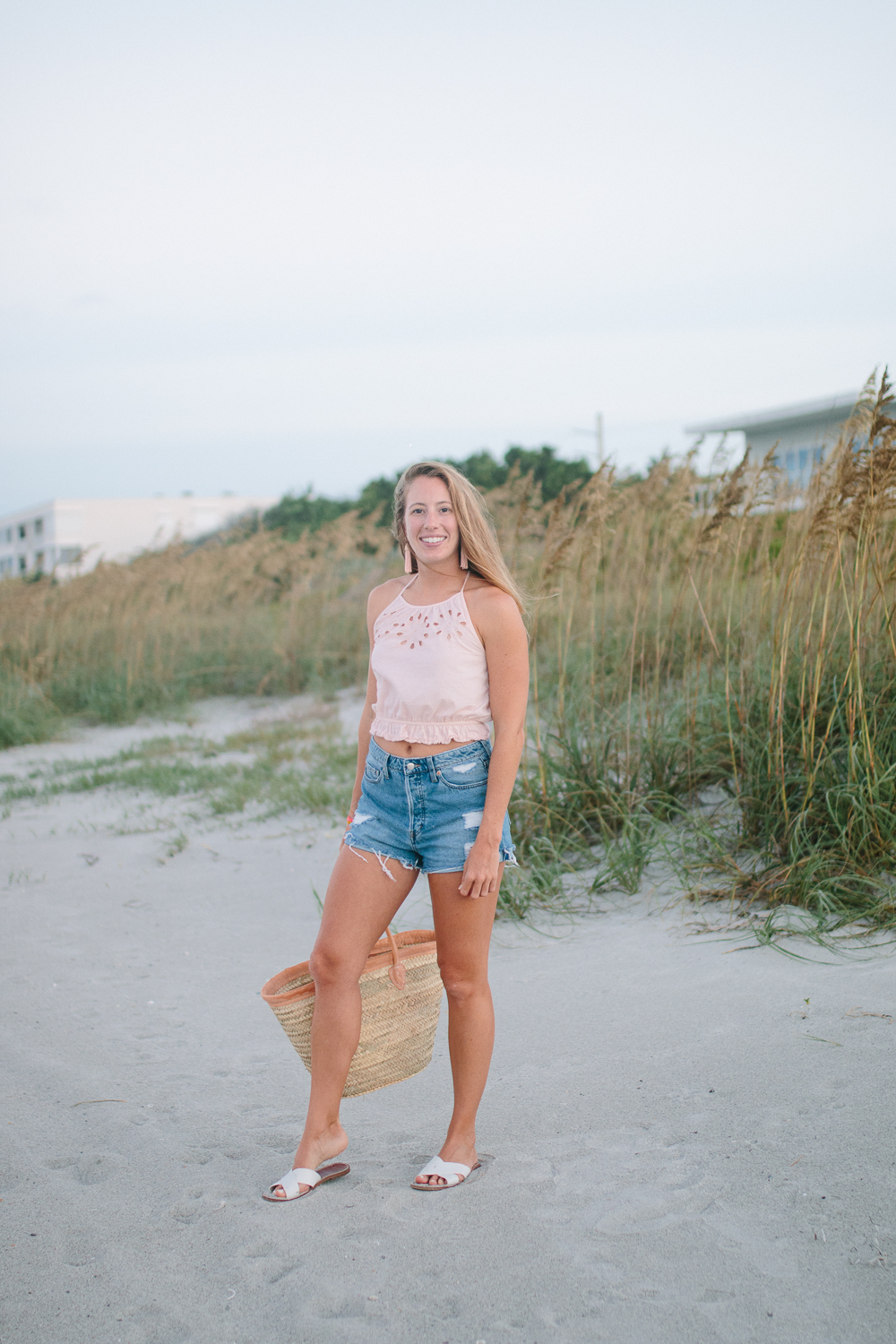 What to Wear to the Beach: A Casual Summer Outfit featuring an Aerie Crop Top, Denim Shorts, Sandals, Statement Earrings and a Beach Bag | Sunshine Style