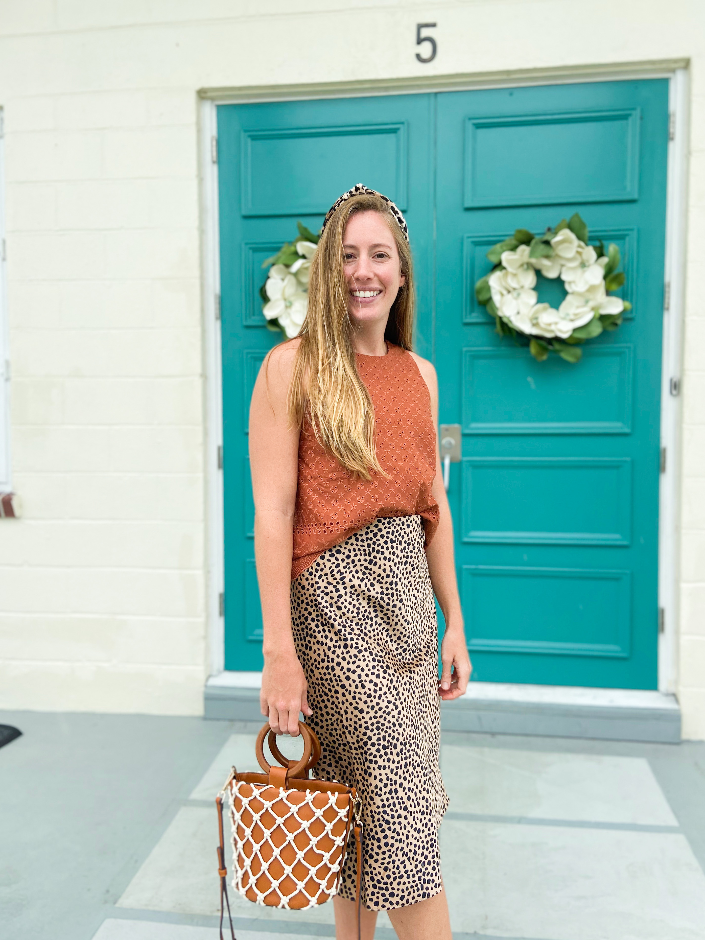 woman sharing how to style a leopard skirt with brown top