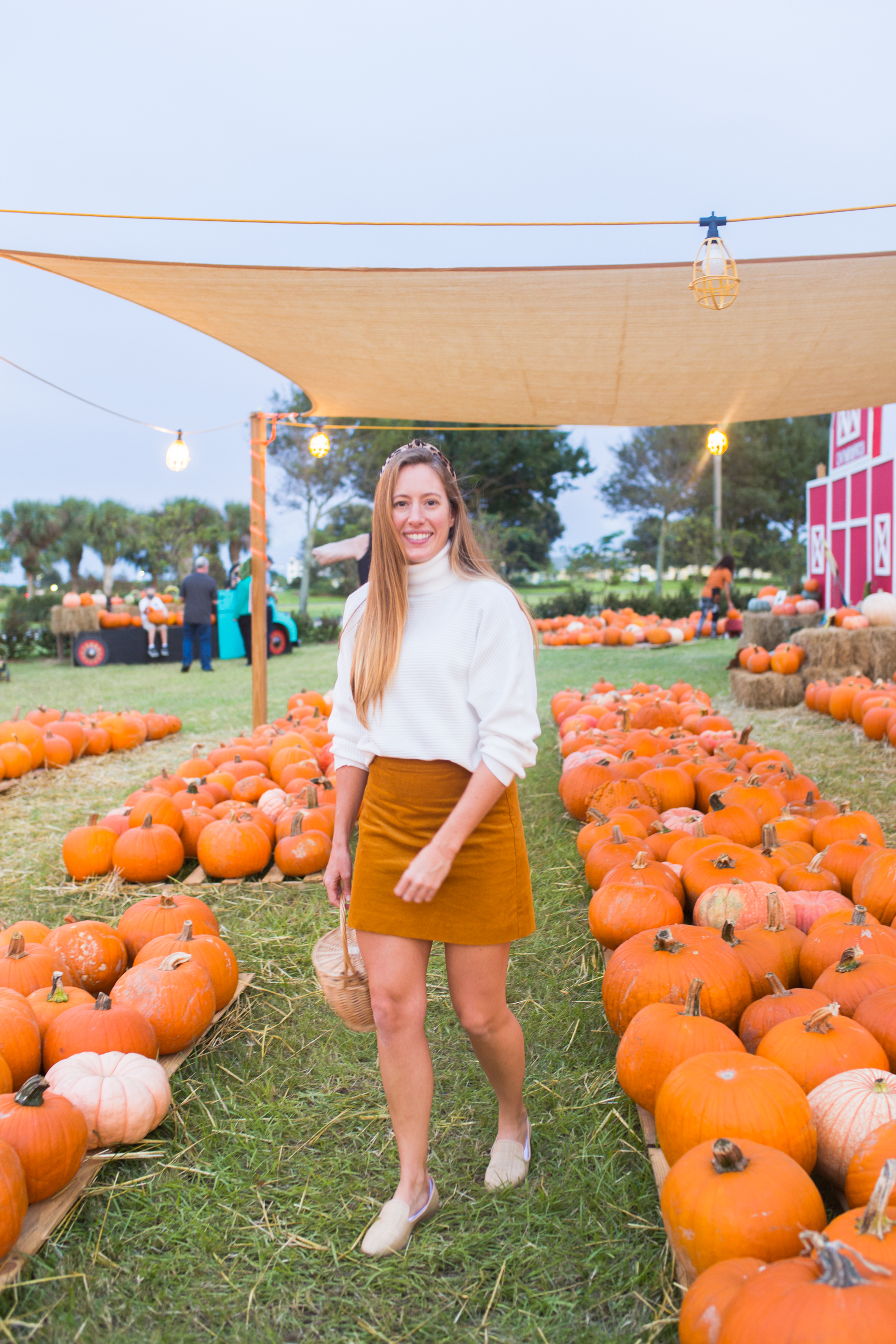 woman in white top and orange skirt