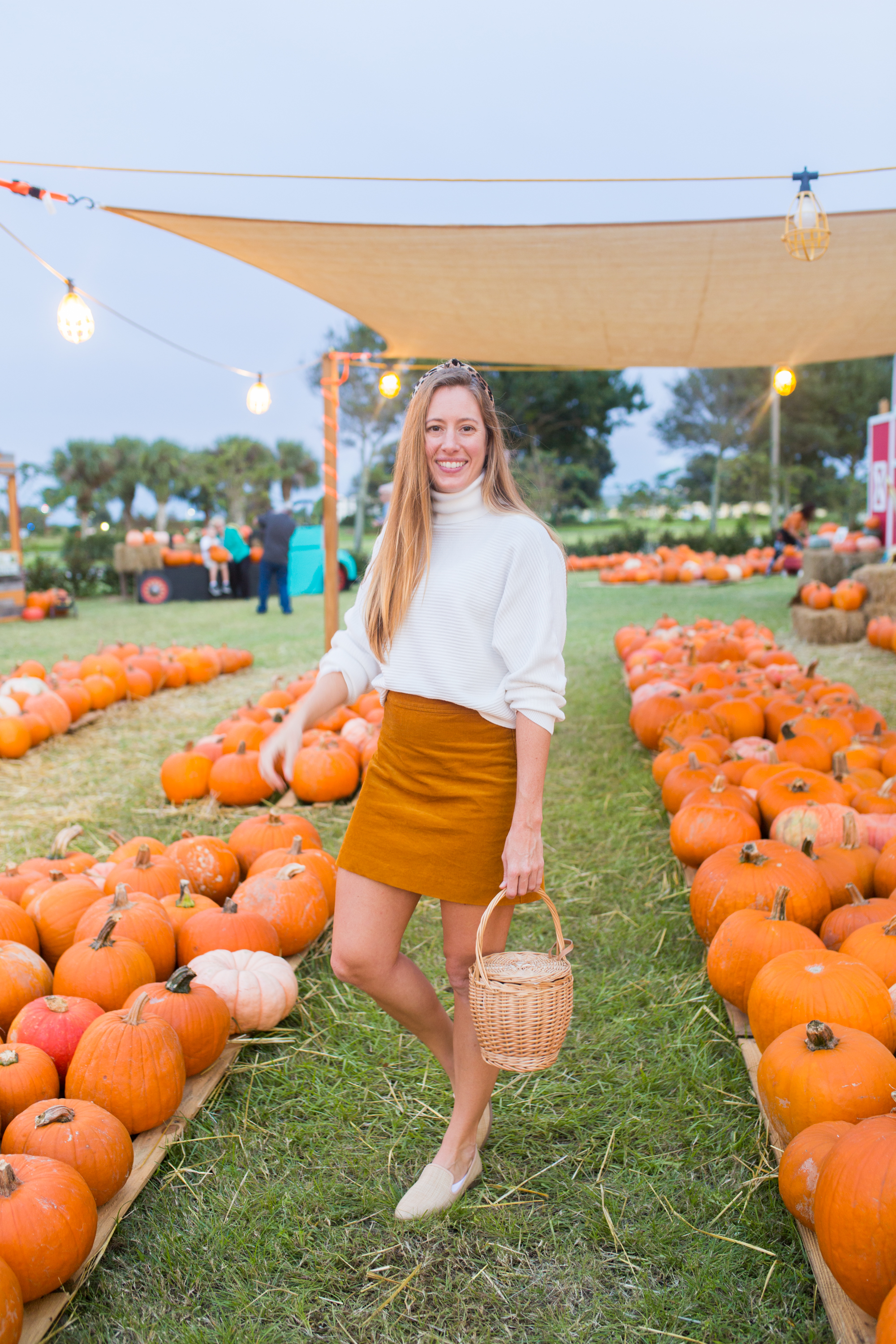 woman in orange skirt and white sweater for Fall Transition Outfit 