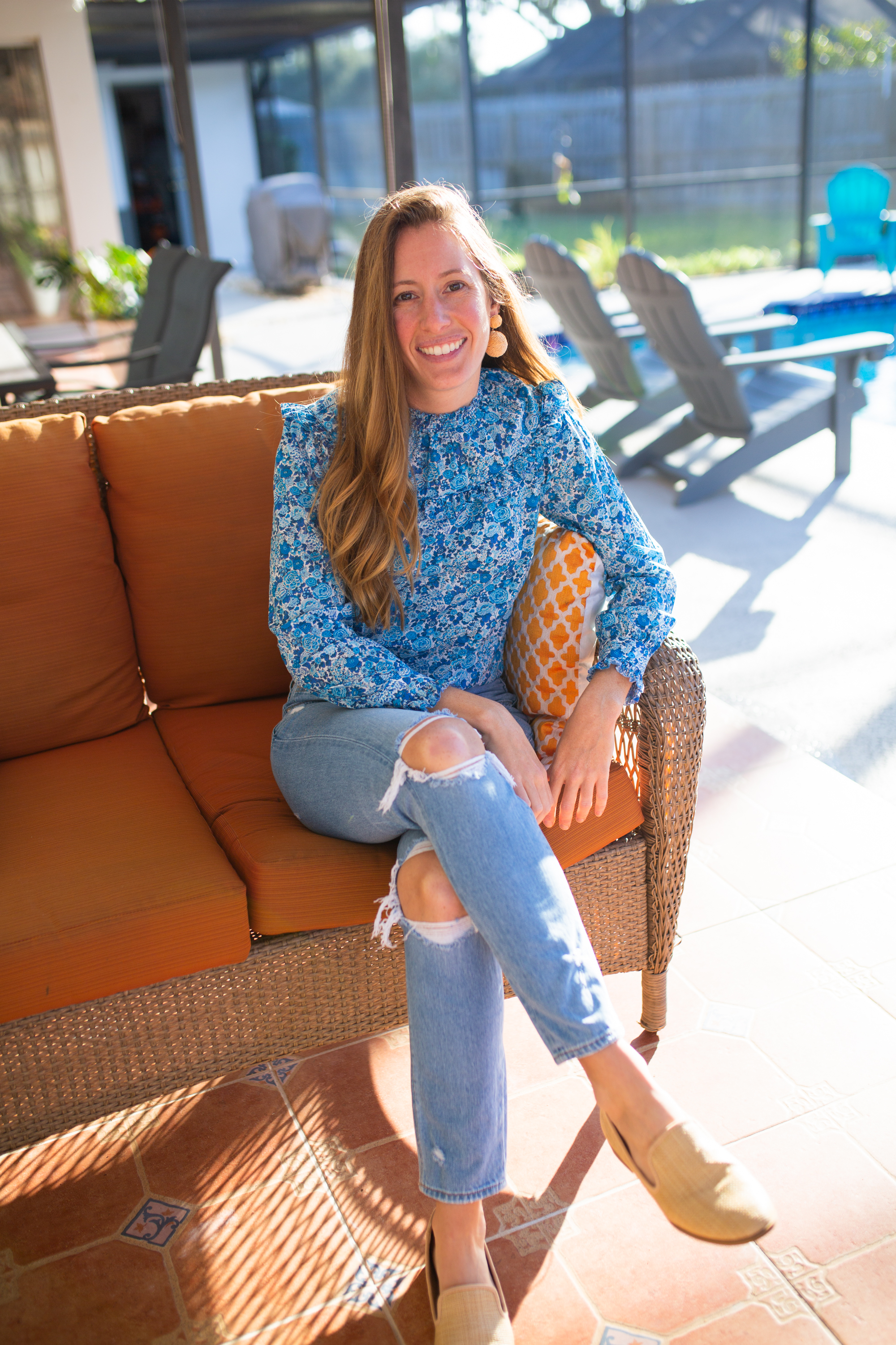 J.Crew Liberty Print and wearing tattered jeans and sitting near the pool