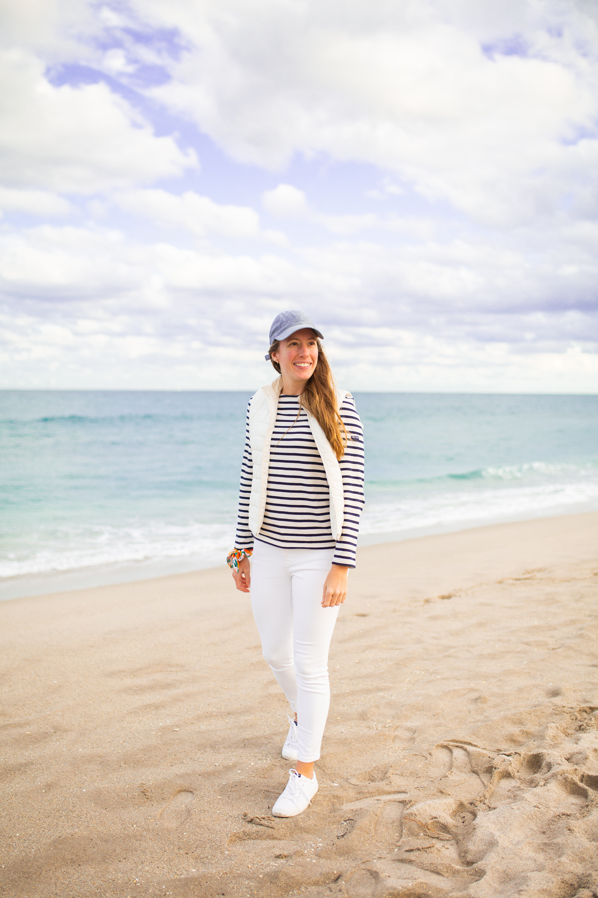 woman at the beach wearing Saint James Striped Shirt  and white pants 