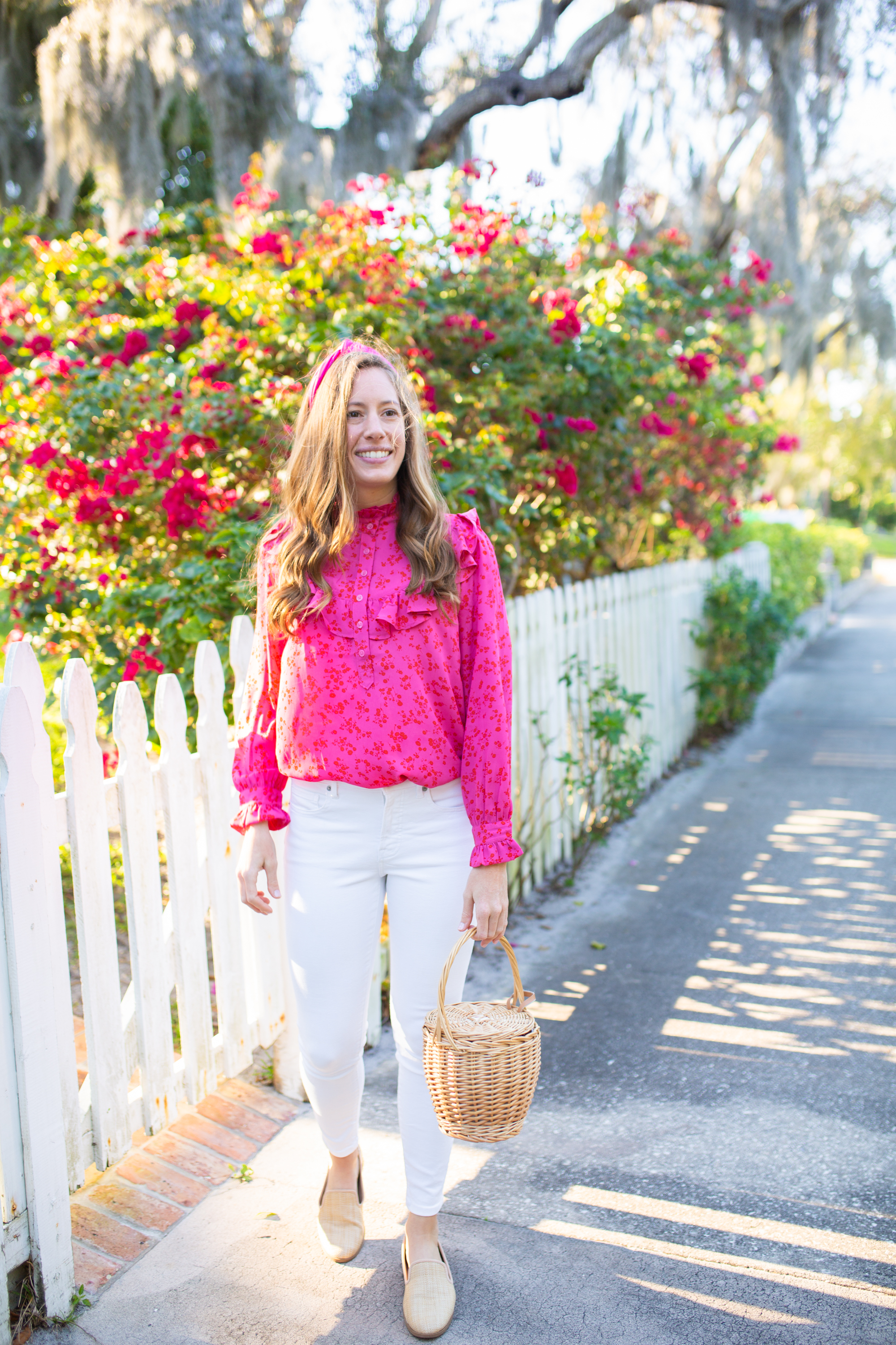 woman wearing Floral Tops for Spring with Ruffle, White Jeans, pink headband, and nude flats