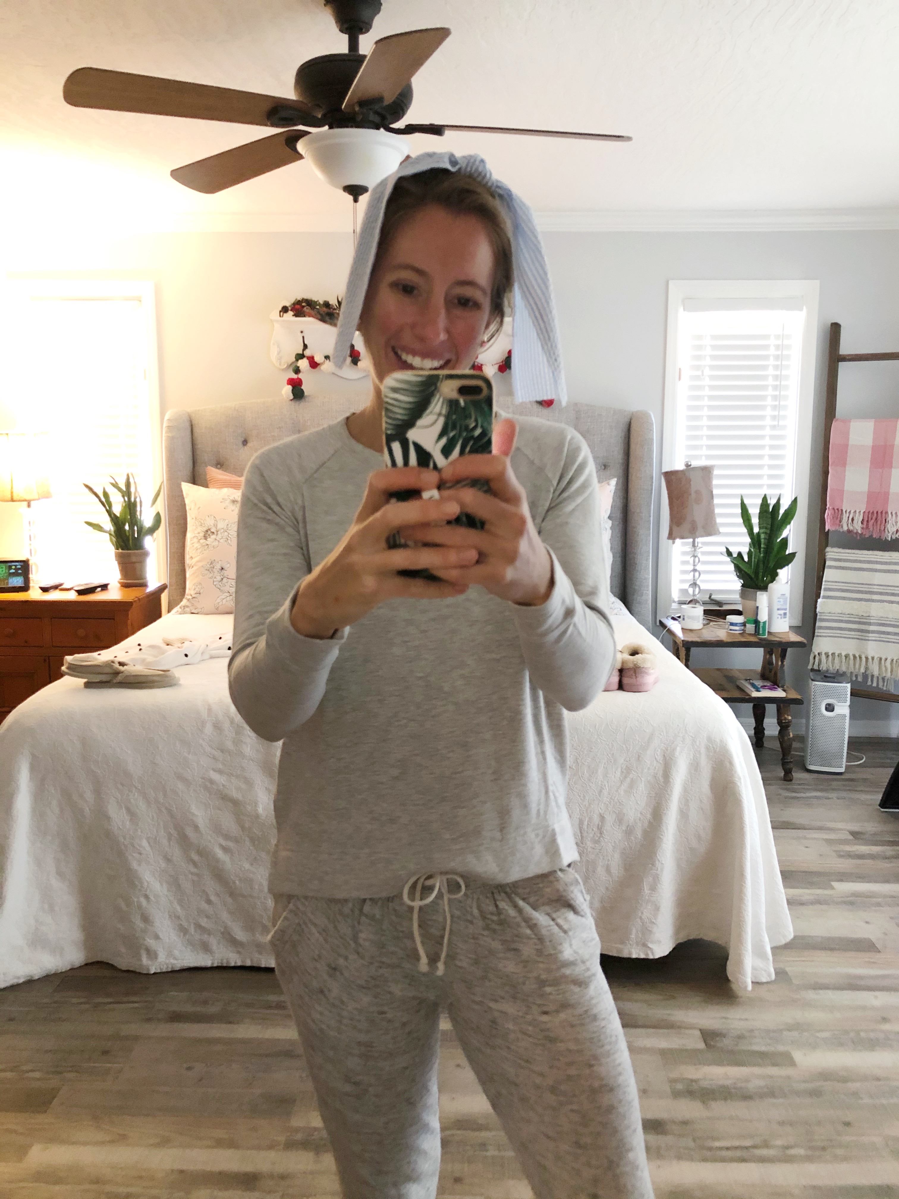 woman taking a selfie in her bedroom showing how to balance a working full time and running a business
