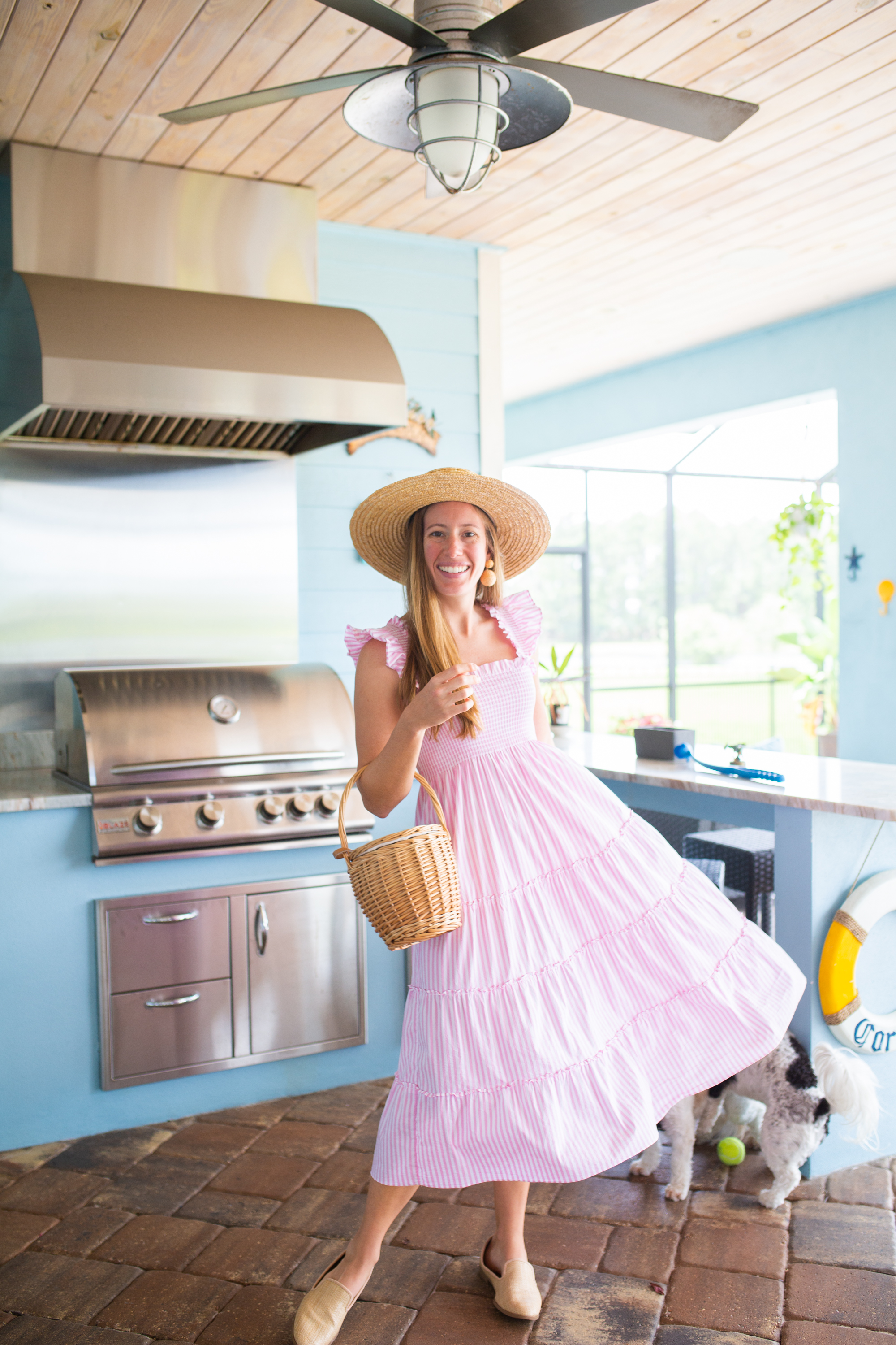 woman in the kitchen wearing pink dress and a hat for Nap Dress Review