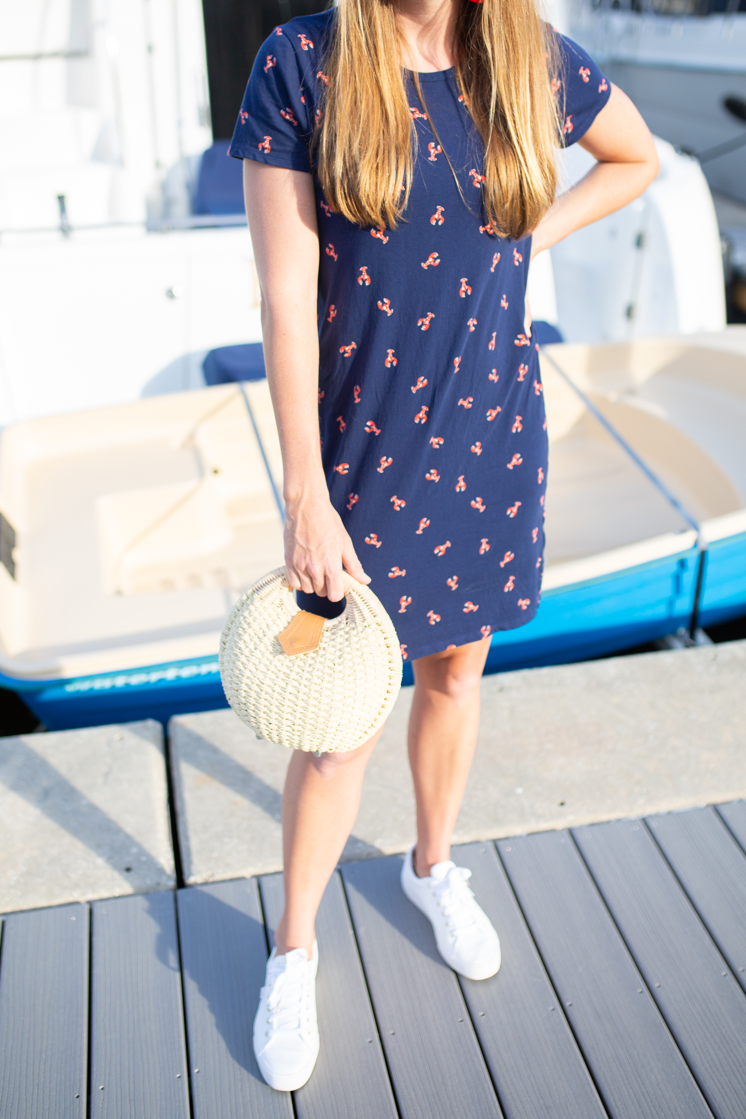 woman sharing Ways to Wear a T-Shirt Dress with white shoes and weaved bag