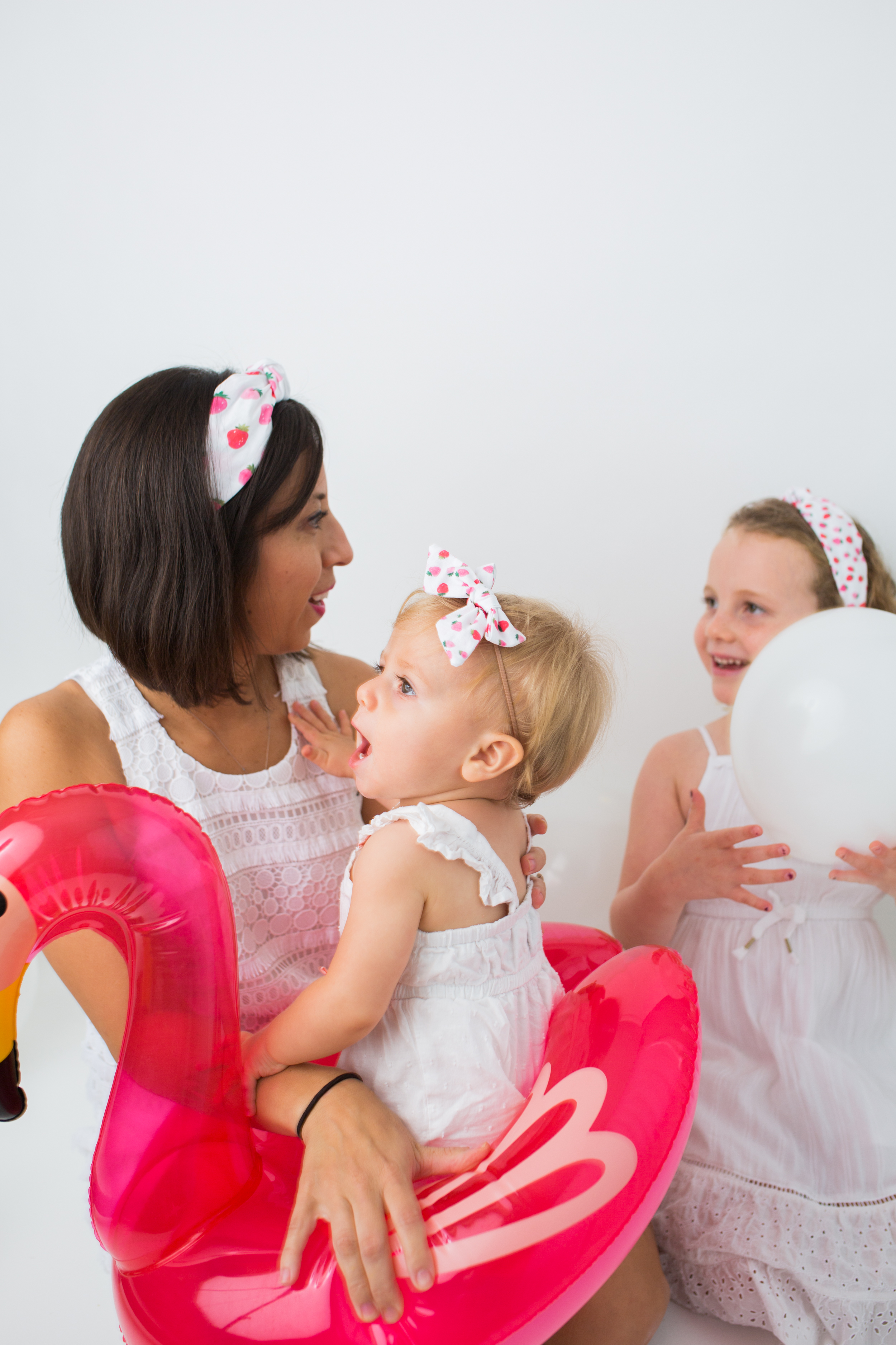 mom and kids wearing white dresses and cherry printed headbands from Sunshine Style Headbands