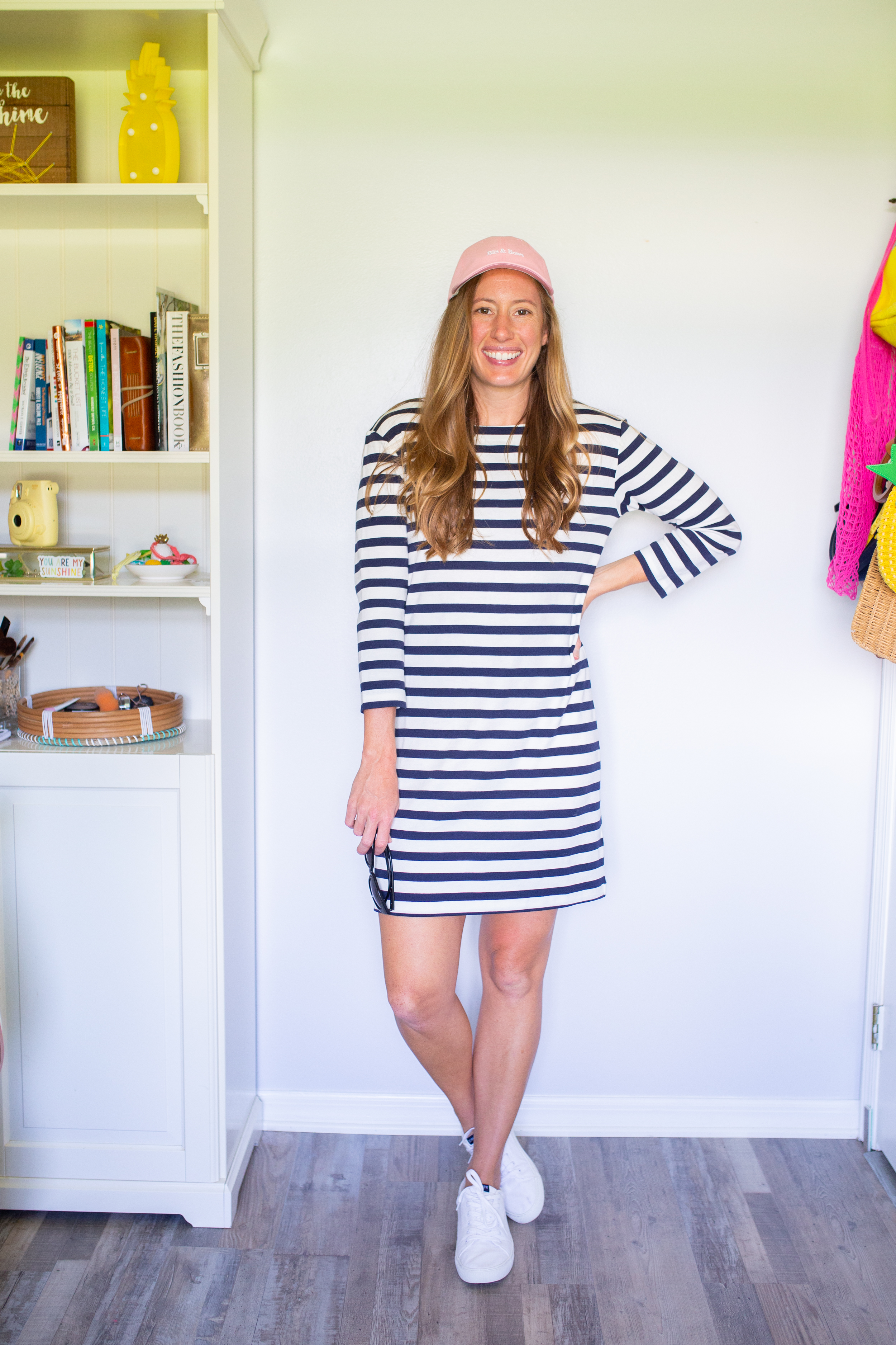 woman in pink hat and striped dress