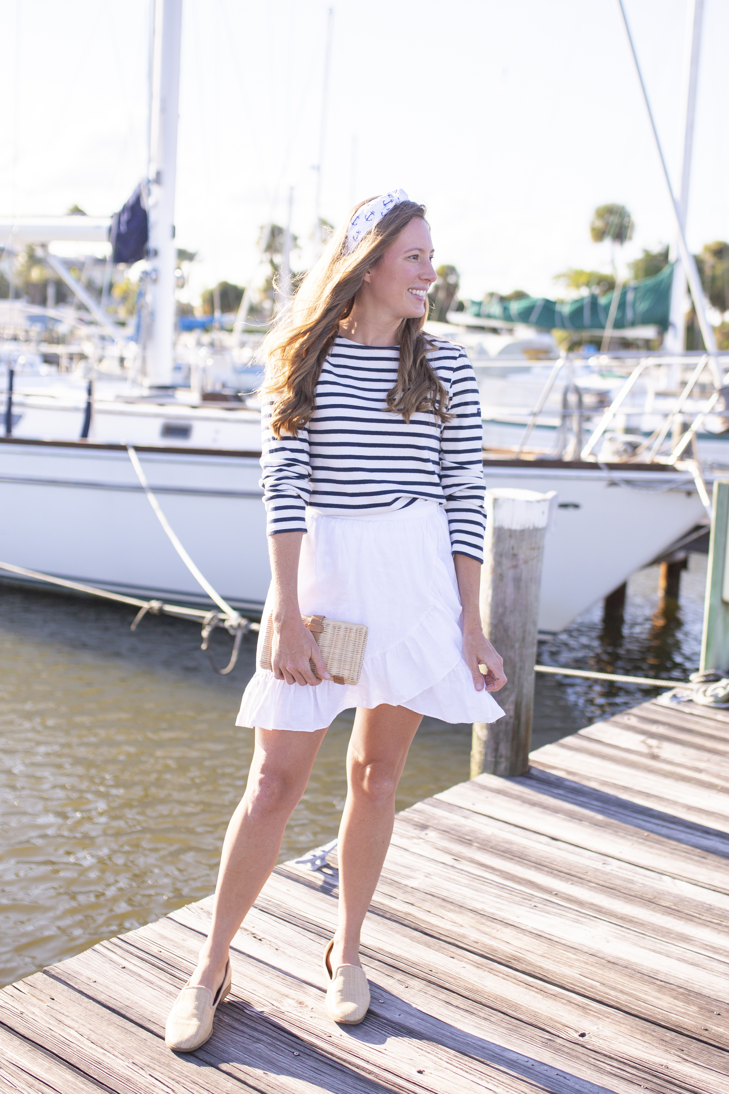 woman in stripes top and white skirt