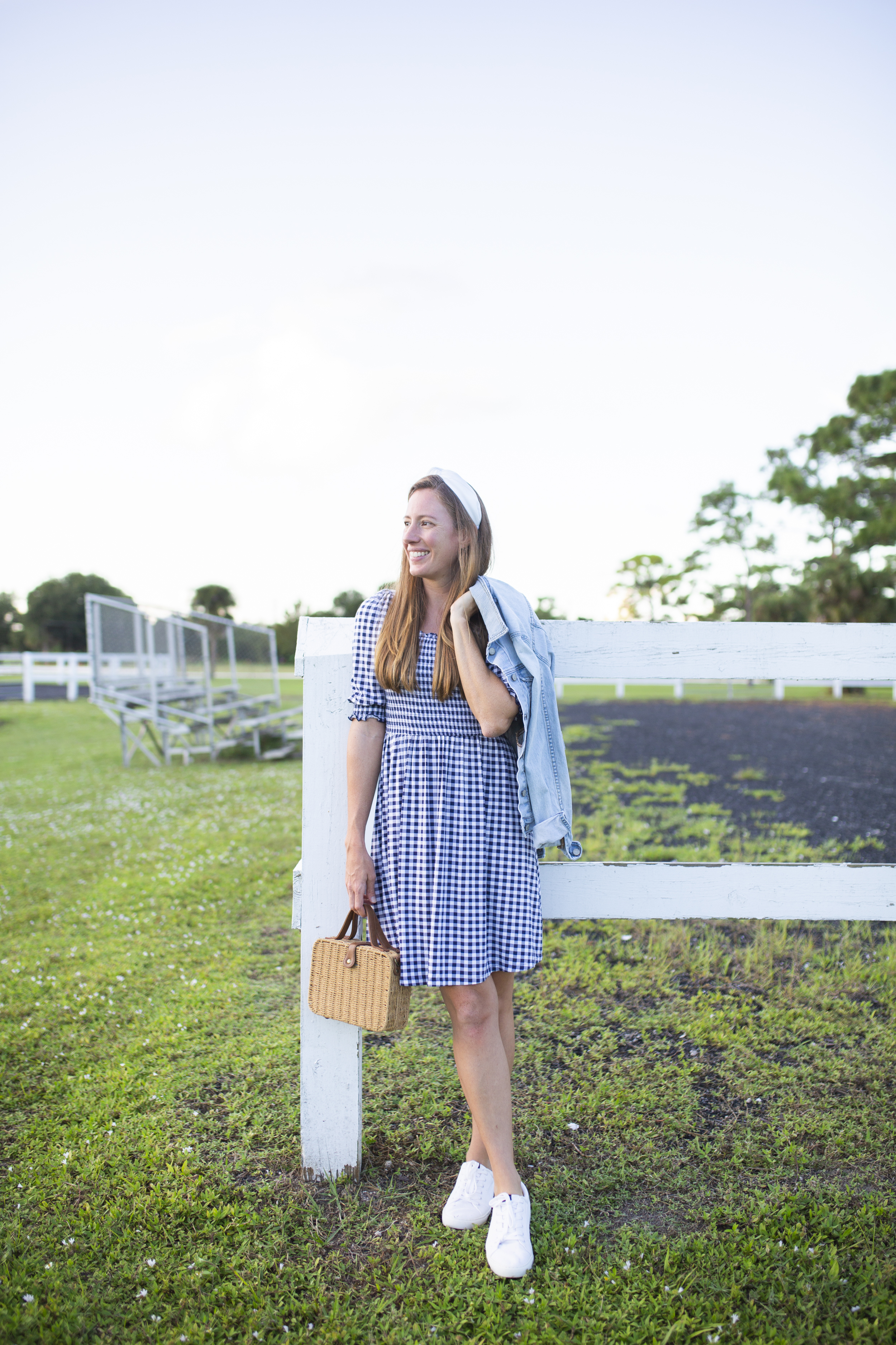 woman wearing Draper James Dress and leaning on the fence