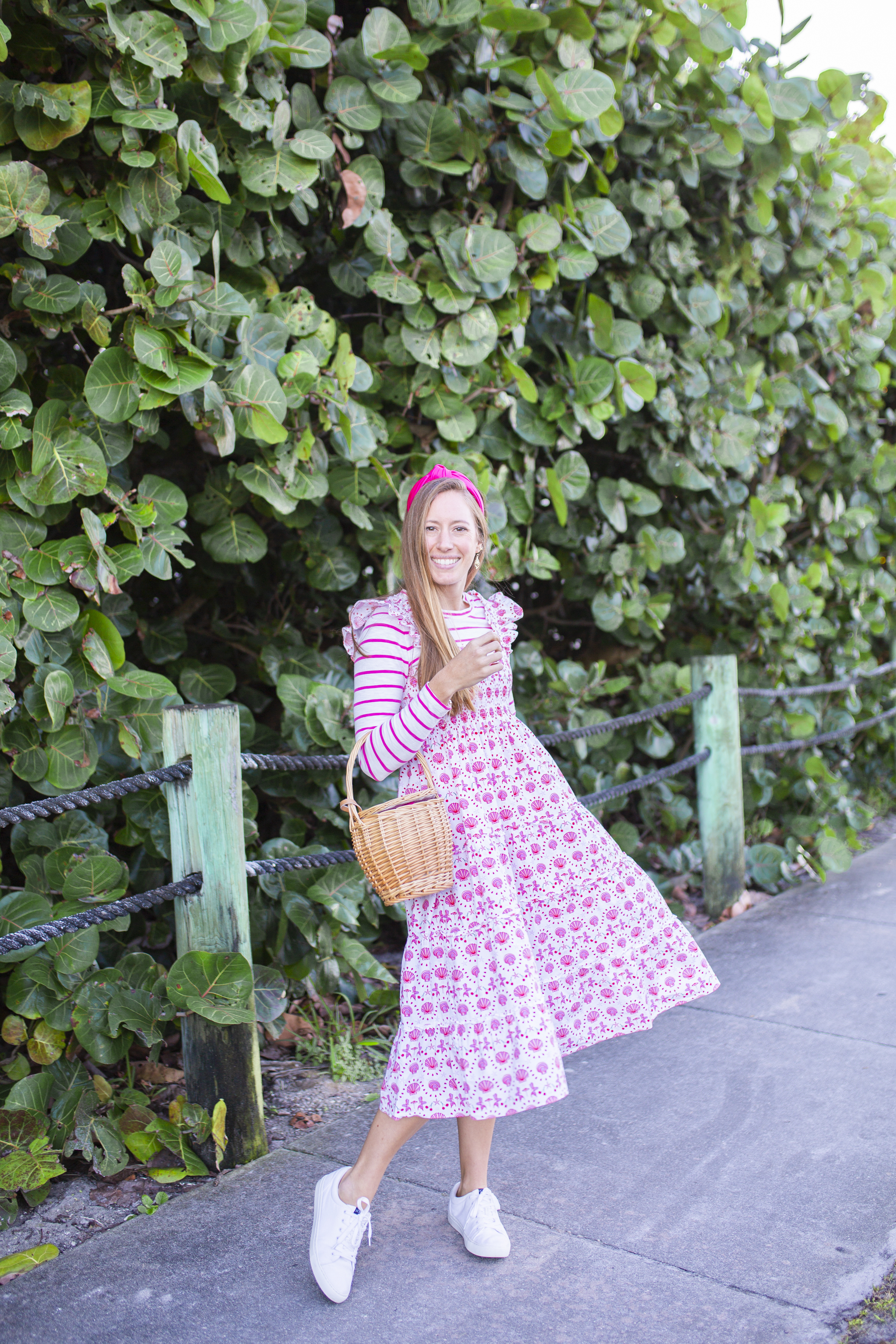 woman sharing how Styling a Nap Dress with white shoes and bag