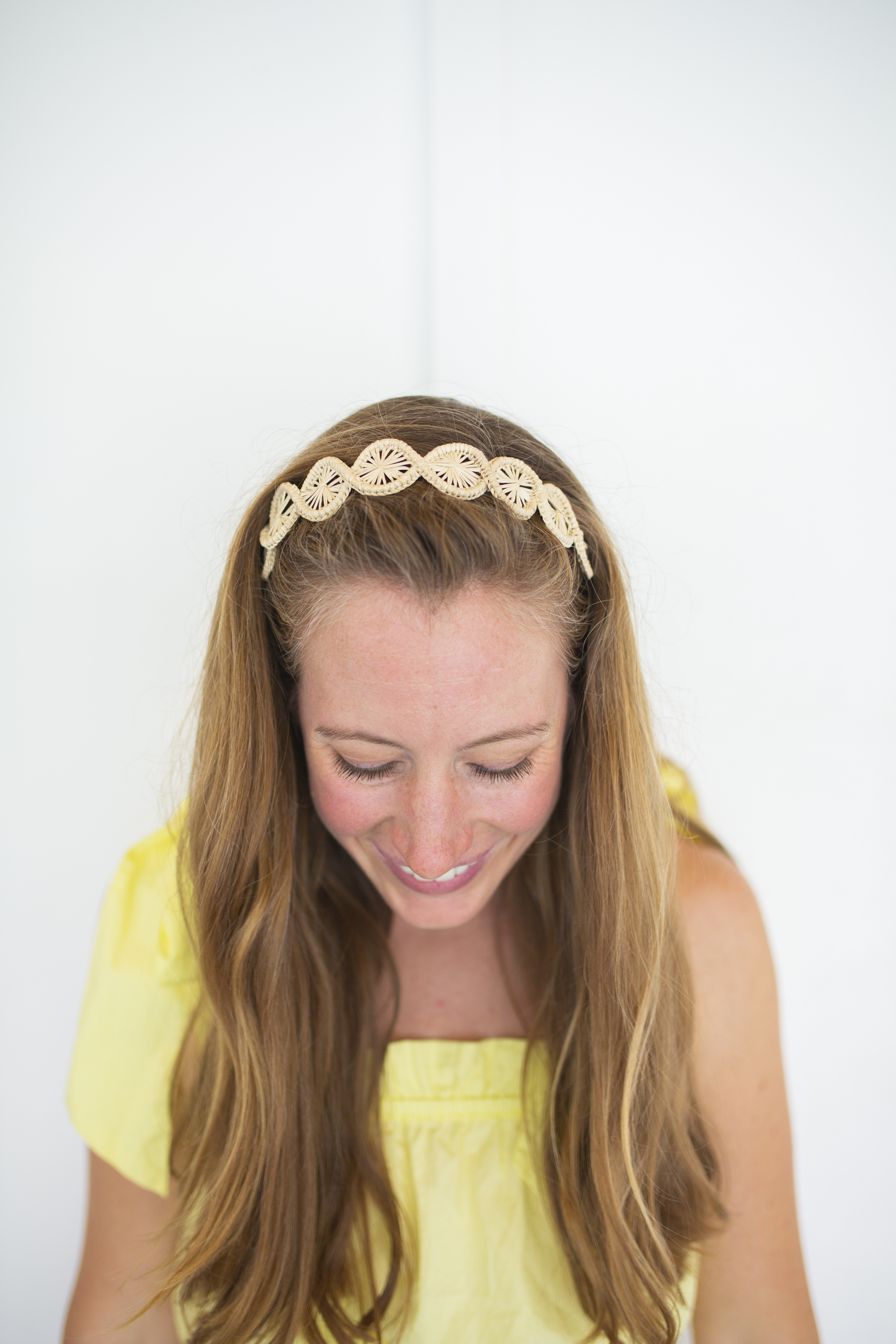 girl wears woven palm headband  with yellow sundress